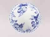 a blue and white plate with a floral design on it