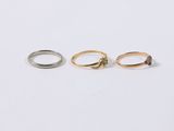 three gold and silver rings on a white background