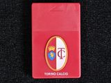 a close up of a red cigarette case on a black surface