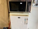 an image of a kitchen with a microwave and a trash can