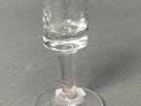 a wine glass that is sitting on top of a table