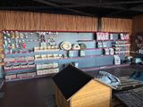 a dog house in the middle of a room with lots of supplies