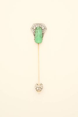 a close up of a green and white broocher on a stick