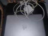 a laptop computer sitting on top of a wicker chair