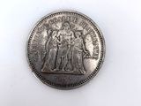 a close up of a coin on a white surface