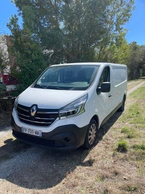 a white van parked on the side of a dirt road