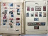 two open books with stamps on them sitting on a table