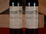 two bottles of wine sitting next to each other on a table