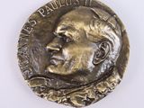 a close up of a coin with a man ' s face on it