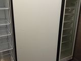 an empty refrigerator in the corner of a room