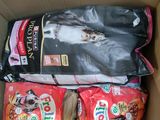 three bags of cat food in a cardboard box