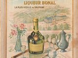 painting of a bottle of liquor on a tray next to a vase of flowers