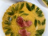 a yellow plate with flowers on it next to a bowl