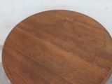 a small table with a wooden top on a cement floor