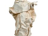 statue of a man in a white robe with his arms outstretched