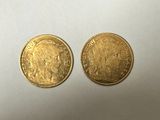 two gold coins, one of which has a head of a man and the other of which is a woman