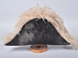 a black hat with a feather on top of a wooden stand