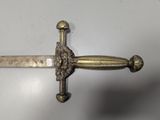 a sword with a lion head on it on a table