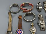 many different types of watches and bracelets on the table