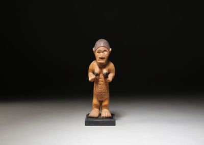 a small figurine of a man with a hat on his head