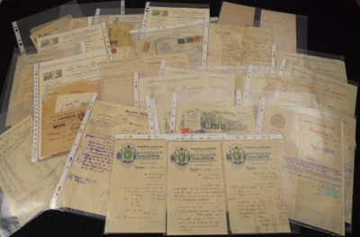 a pile of old letters and envelopes sitting on a table