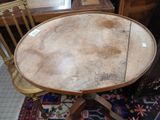 a round table with a wooden top and a wooden chair