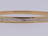 a close up of a gold ring with diamonds on it