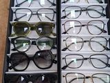 many pairs of glasses sitting in a display case