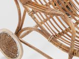 an image of a wicker baby stroller with wheels on a white background