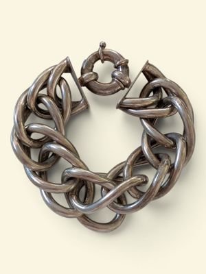 silver chain bracelet on a white background with a flower in the center