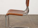an image of a chair with a wooden seat on a wooden floor