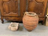 une grande armoire en bois à deux portes avec un vase