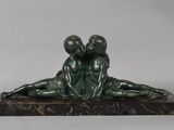 statue of a boy and a girl laying on a marble base