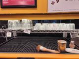 many cups of coffee on the shelf in the store
