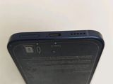 the back of a black cell phone sitting on top of a table