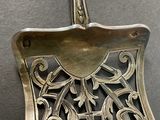 a silver spoon with a decorative design on it