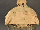 an old hat with a hat on top of it sitting on top of a table