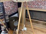 a lamp that is on a tripod stand in a room