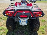 a red four - wheeler atv parked in the grass