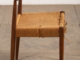 an image of a wooden chair with a woven seat on a wooden floor