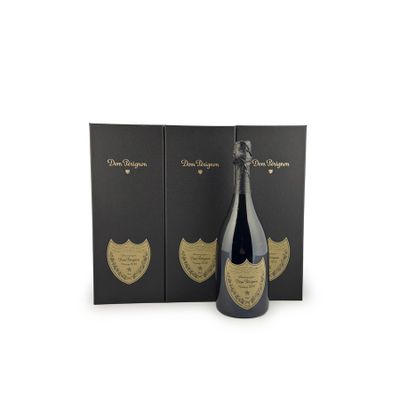 a bottle of champagne in front of two black boxes
