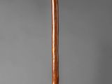 a baseball bat that is standing up on a stand