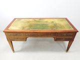 an old desk with a glass top and wooden legs