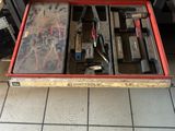 a red tool box with tools in it on a tiled floor