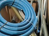 a blue hose sitting on top of a pile of boxes