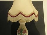 a lamp that is sitting on a table next to a picture