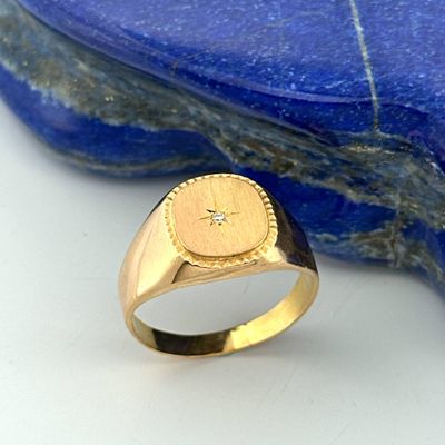yellow gold signet ring with a star on a lapis stone