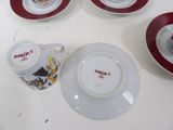 four cups and saucers on a table with a cup and saucer