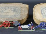 two wooden boxes with figurines of people on them