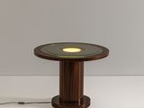 a wooden table with a light on top of it